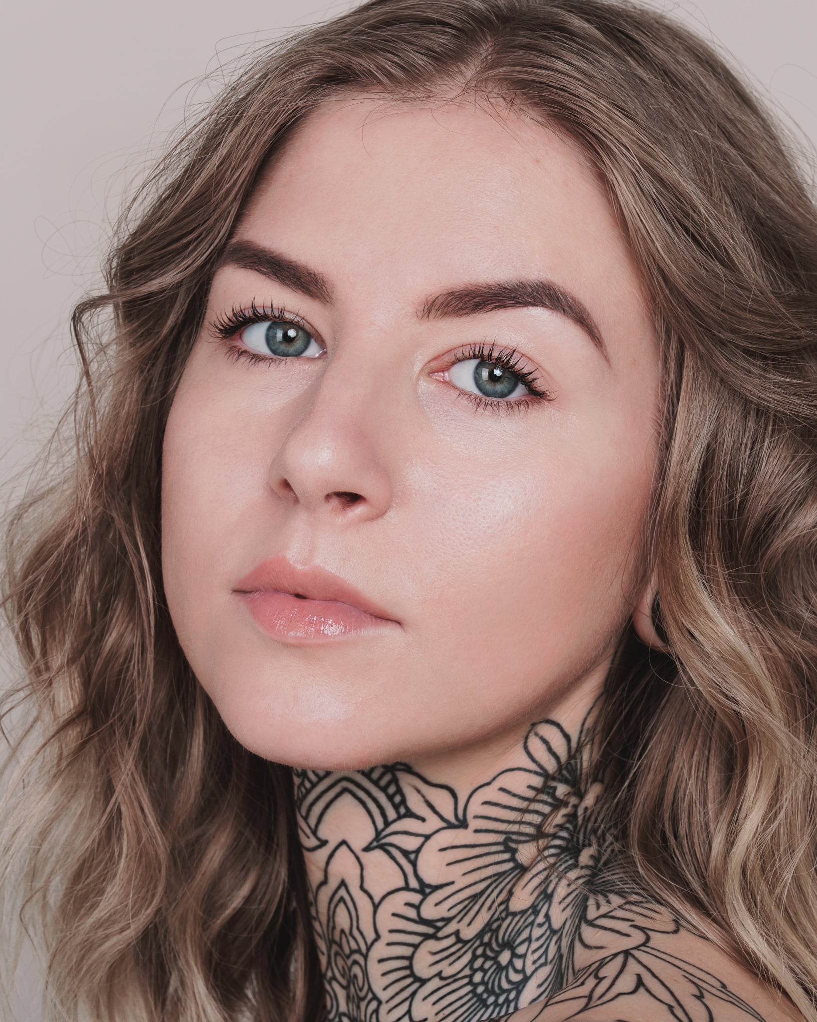 Model wearing MÁDARA Organic Skincare skin equal rose ivory on A6055 on skin; close-up portrait shows natural application results.