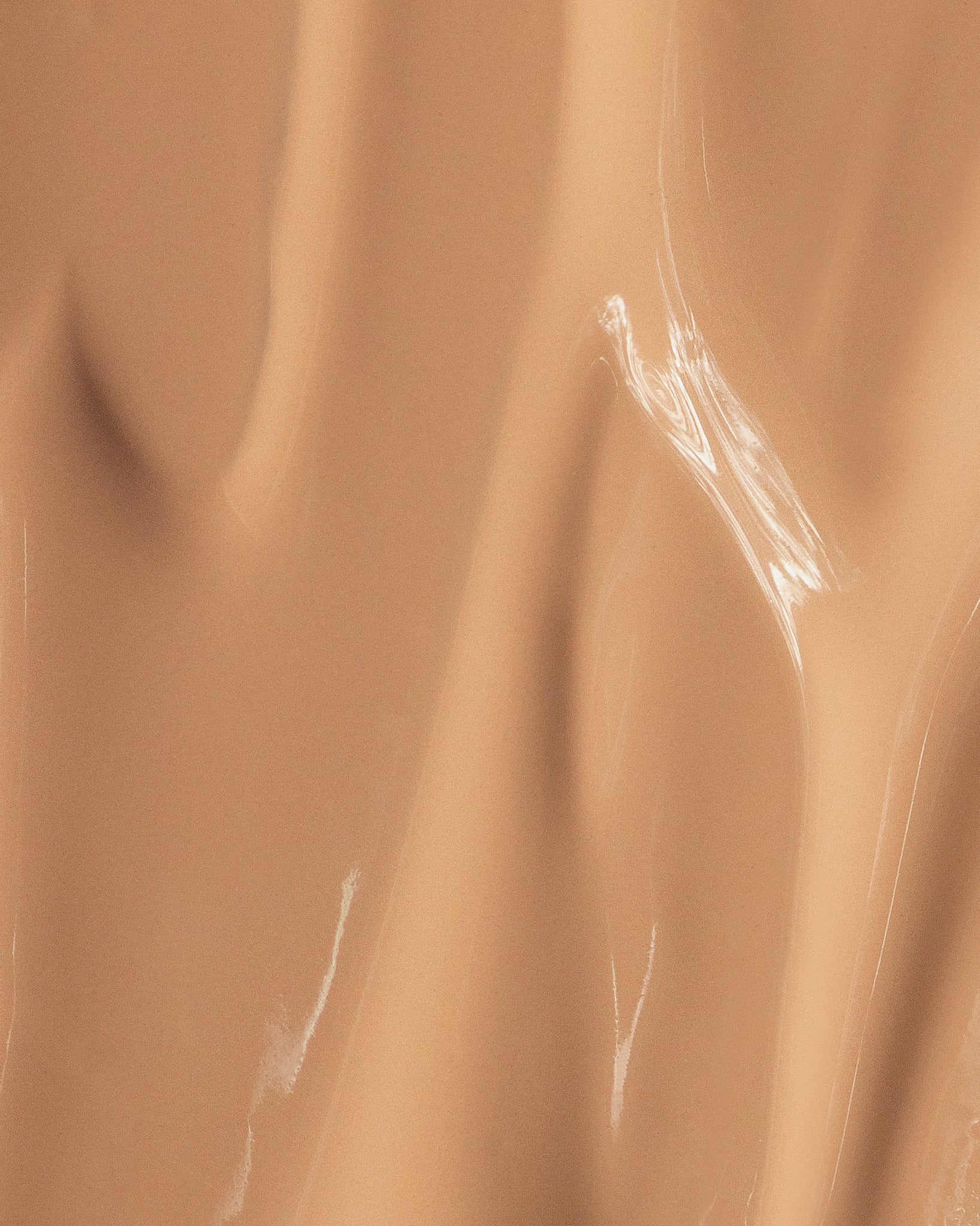 Texture close-up of MÁDARA Organic Skincare skin equal golden sand A6059 �swatch demonstrates consistency and finish.