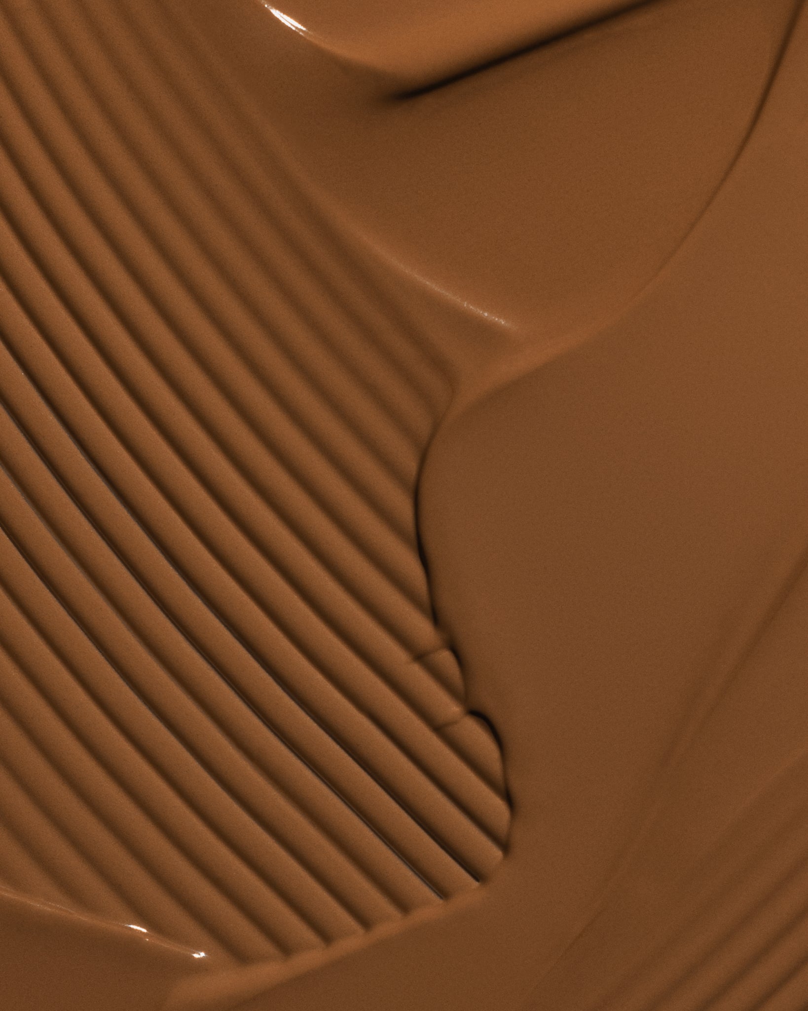 Texture close-up of MÁDARA Organic Skincare skinonym auburn A6094 �swatch demonstrates consistency and finish.