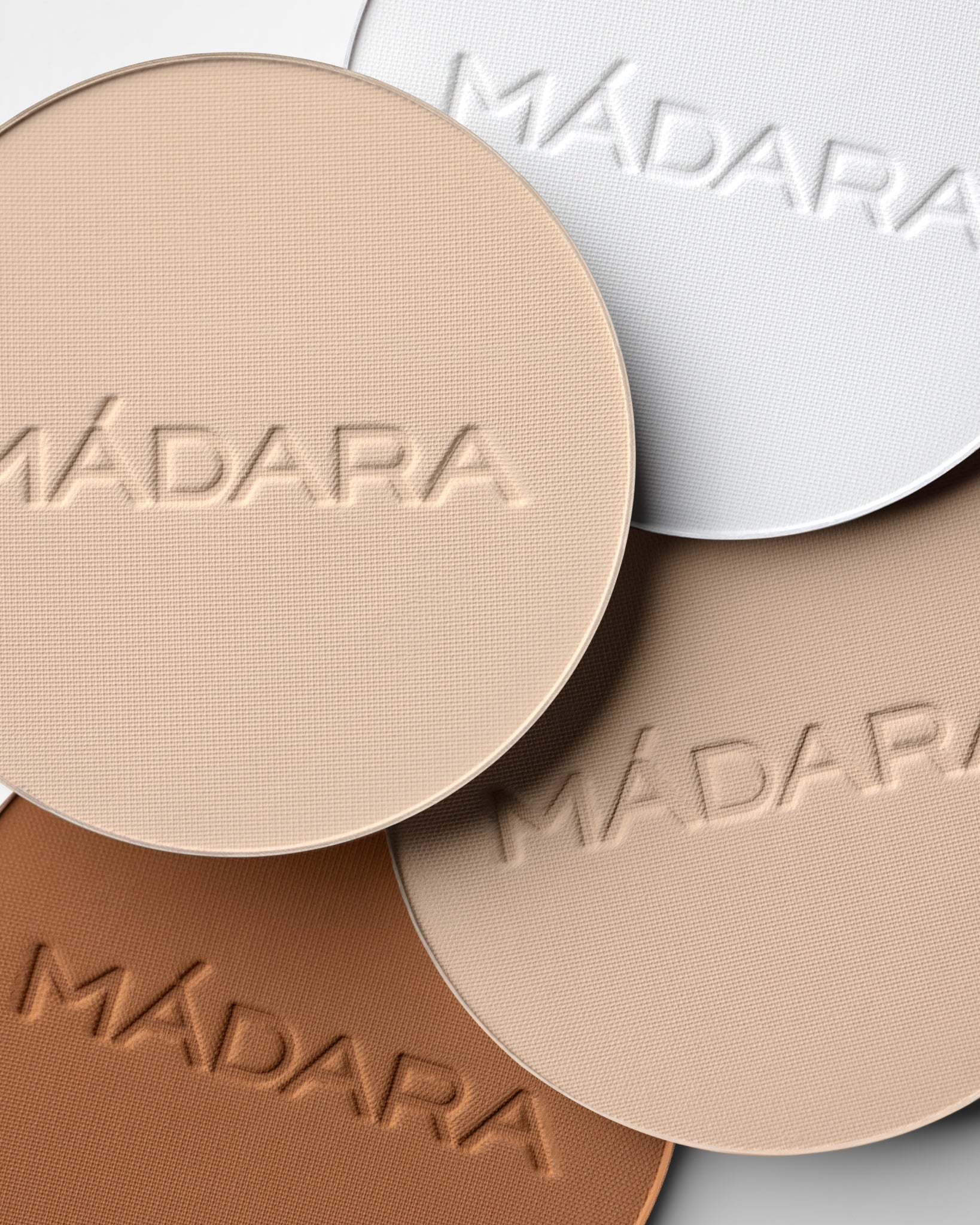 Texture close-up of MÁDARA Organic Skincare soft silk mineral powder textures A6802 �swatch demonstrates consistency and finish.