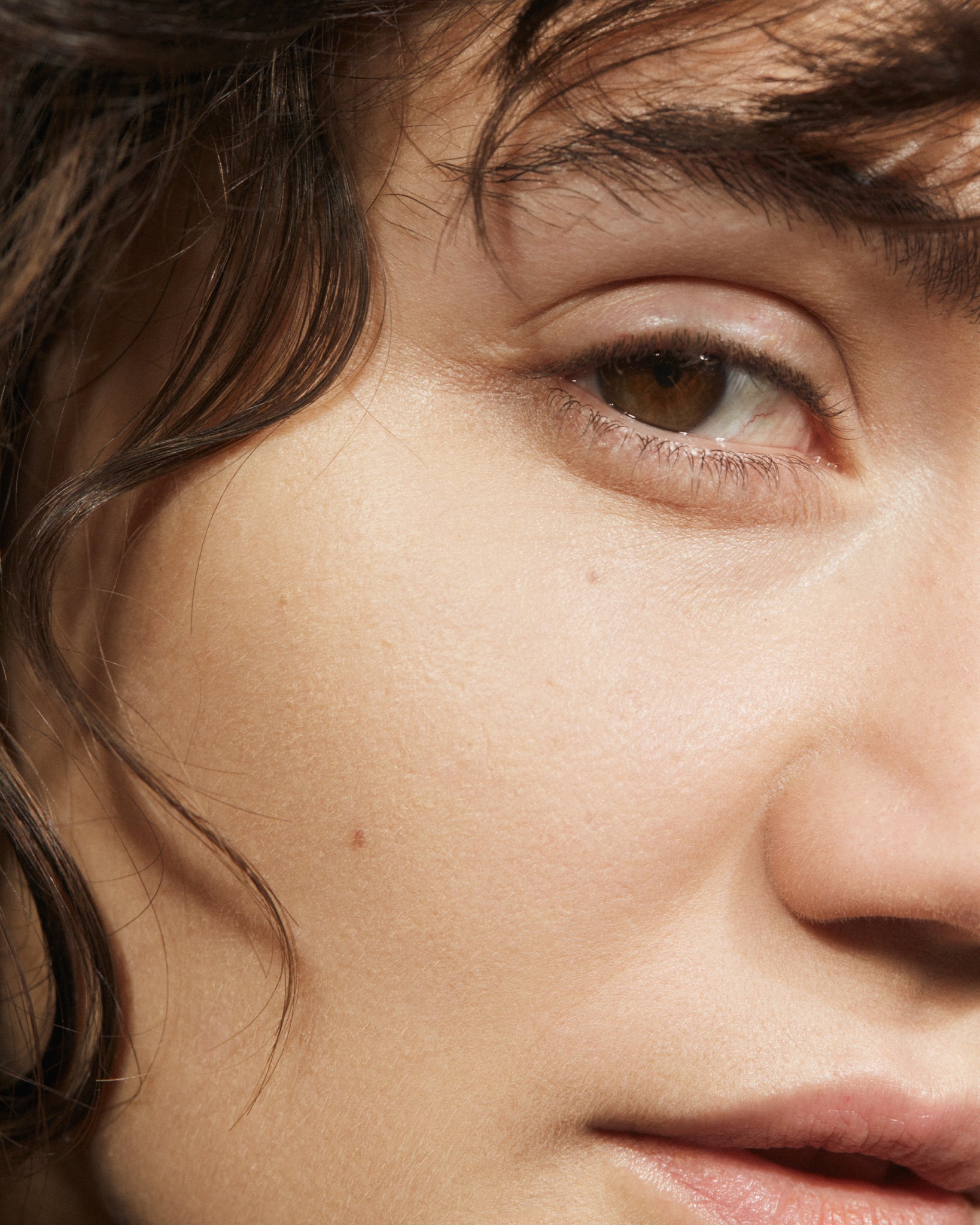 Model wearing MÁDARA Organic Skincare air equal powder fair on A6801 on skin; close-up portrait shows natural application results.