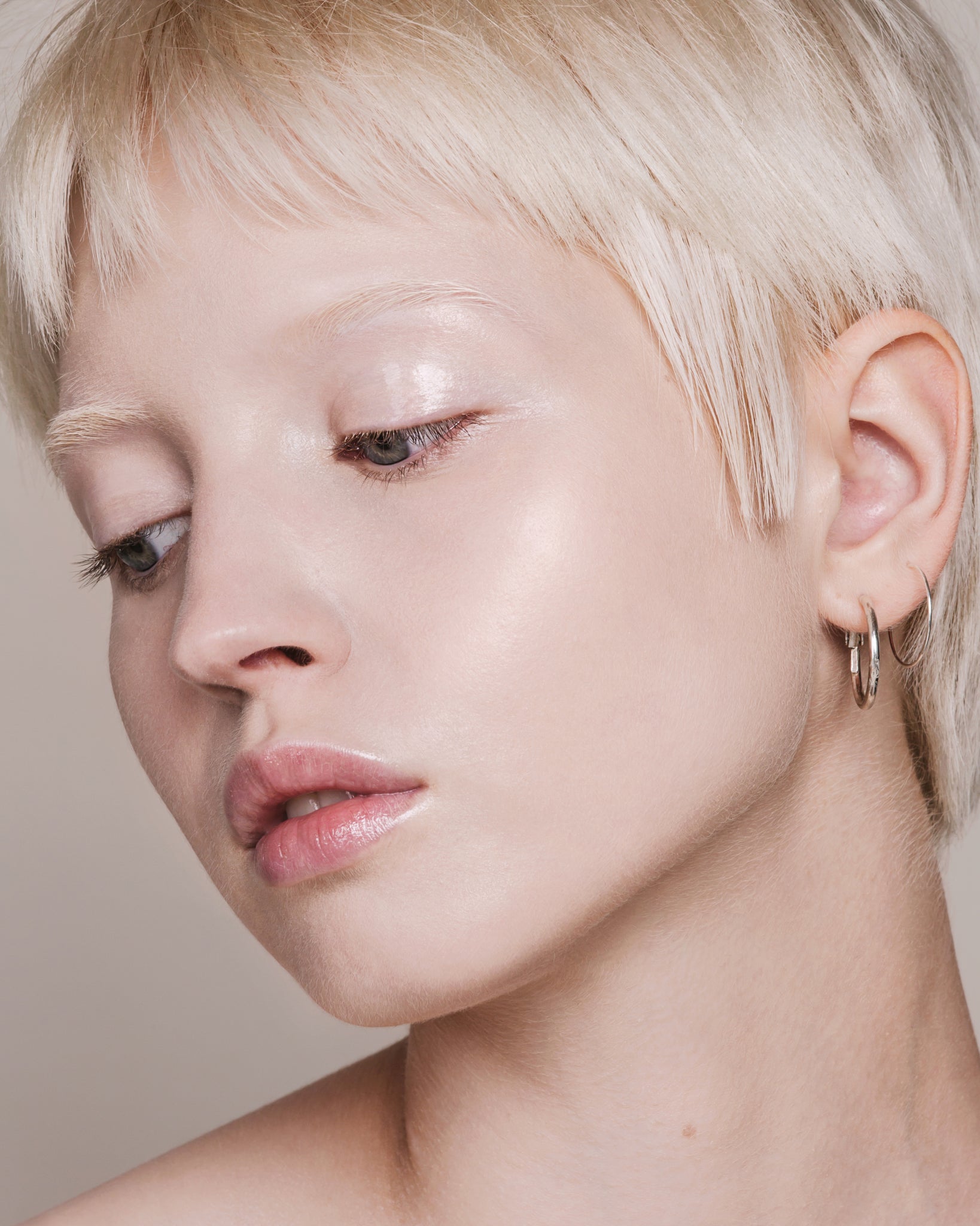 Model wearing MÁDARA Organic Skincare skin equal porcelain on A6051 on skin; close-up portrait shows natural application results.