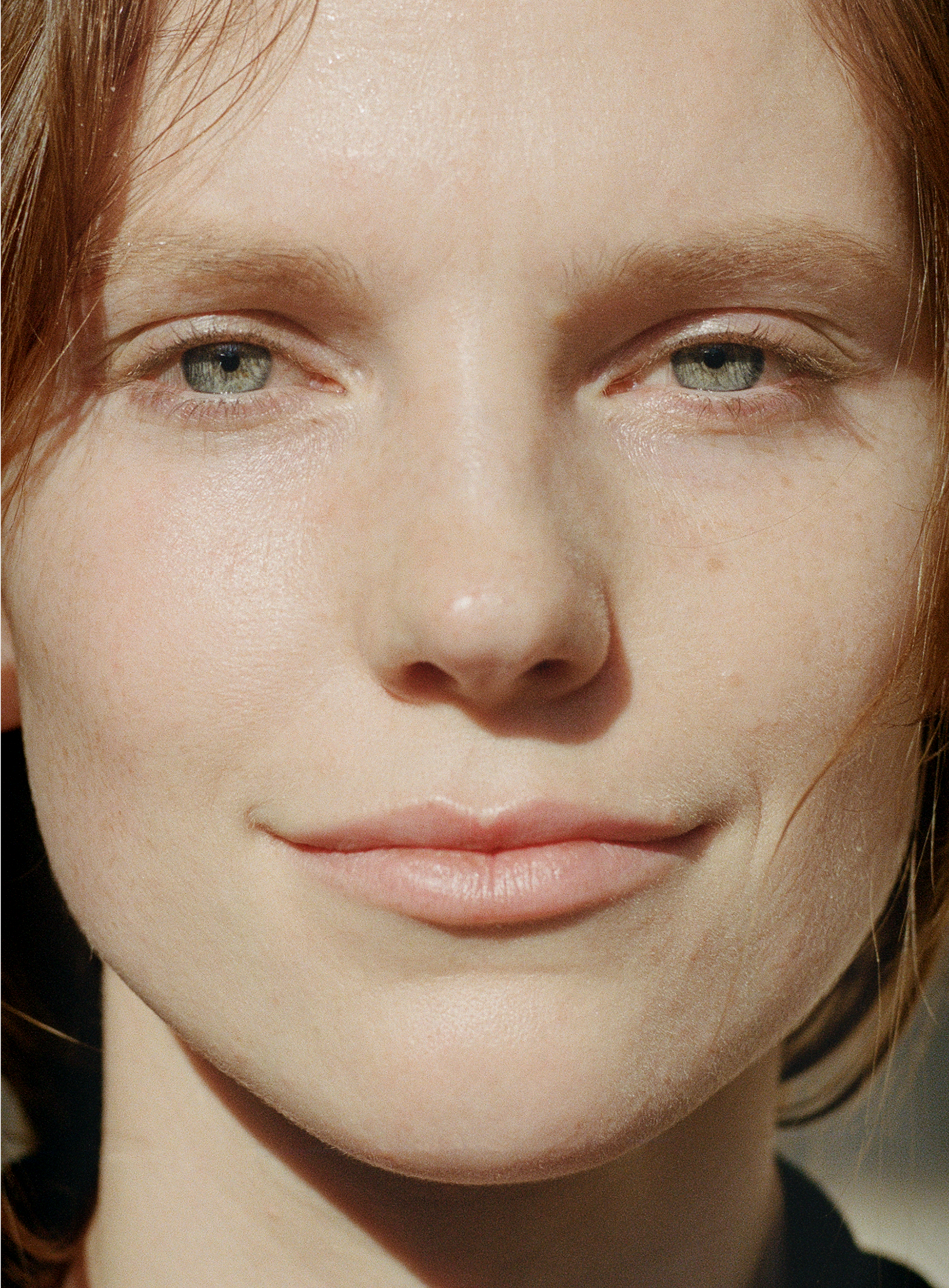 Close-up of a woman with natural glowing skin, minimal makeup, and hydrated complexion representing the effect of MÁDARA Hyaluron Biotic Mist organic skincare